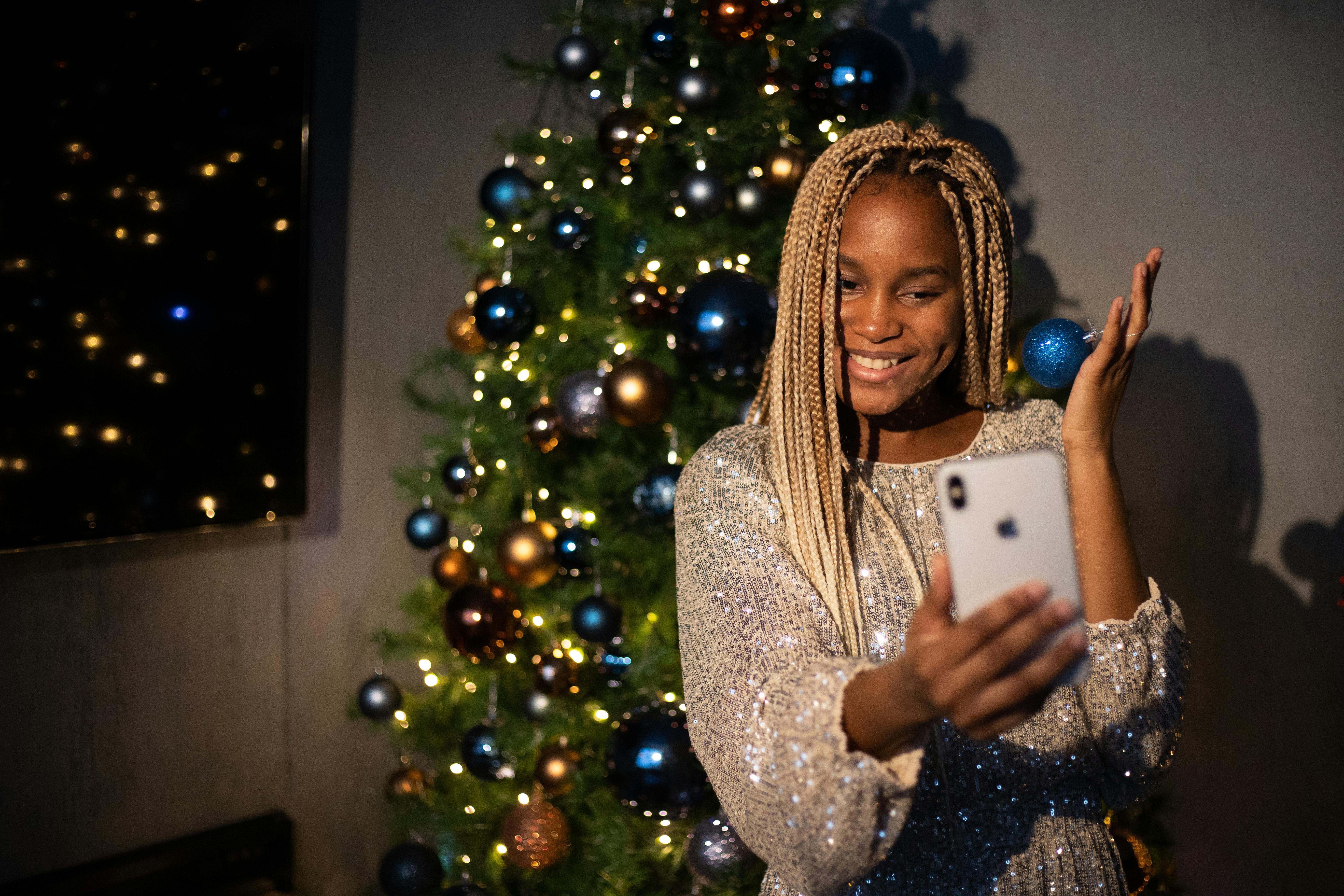 woman holding white smartphone