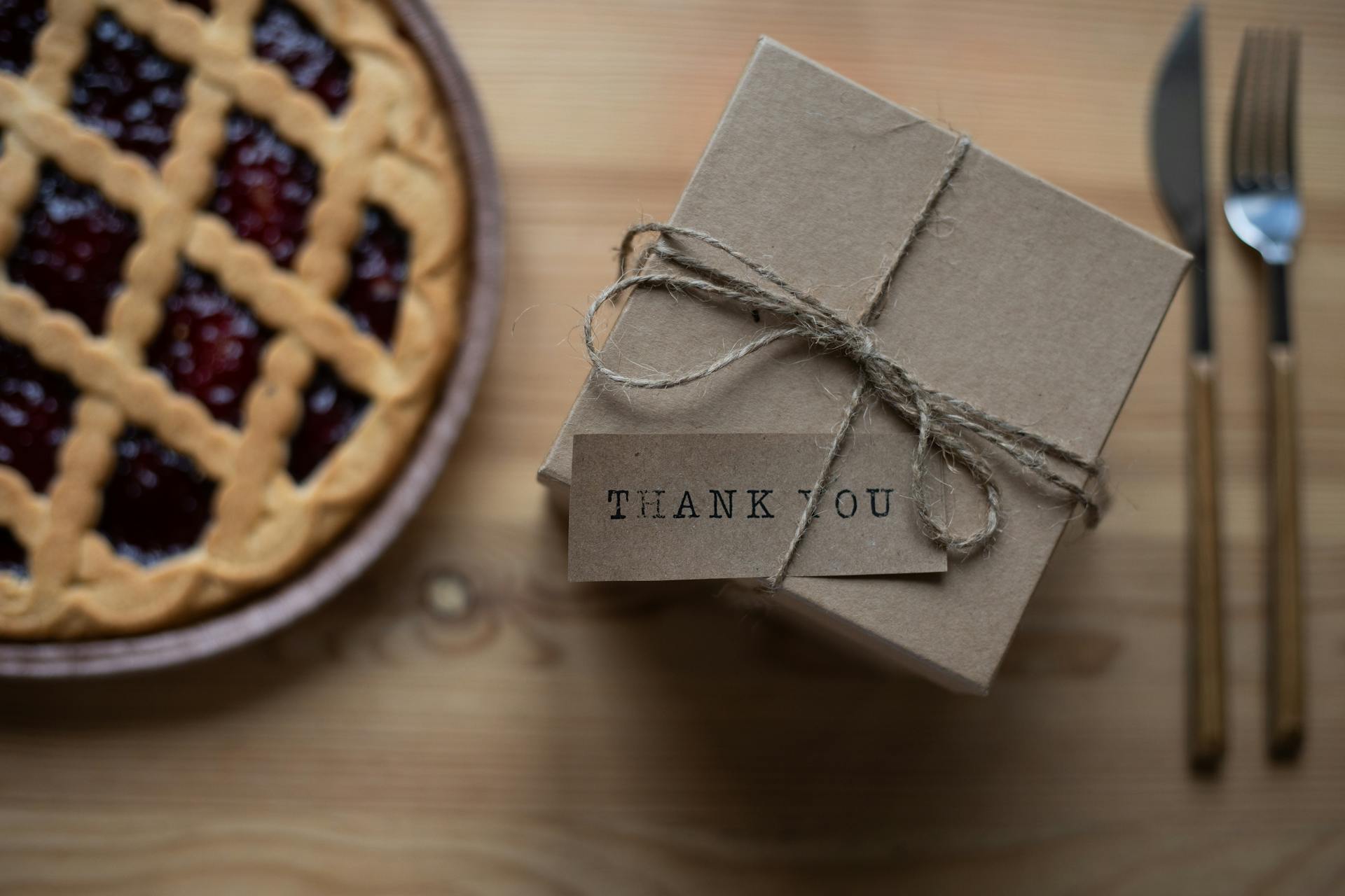 Cardboard present box with postcard on table