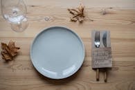 Composition of utensils and tableware on wooden table