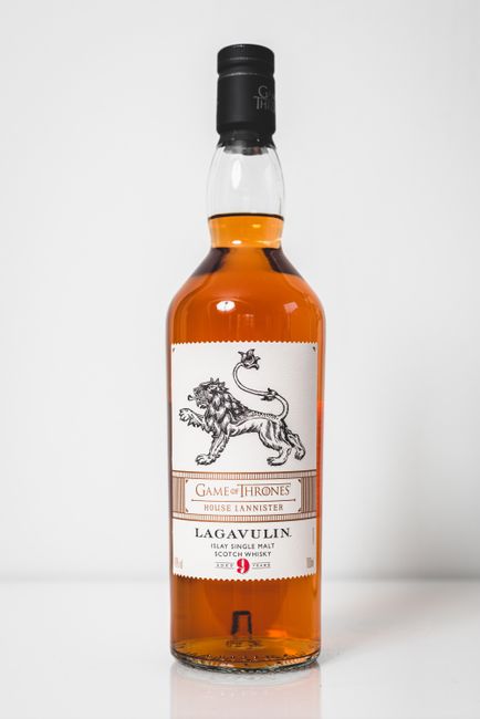 Simple photo of a Lagavulin whiskey bottle themed after Game of Thrones on a white background.