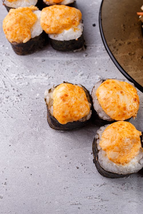 Free From above composition of yummy seafood hot sushi rolls arranged on gray surface Stock Photo