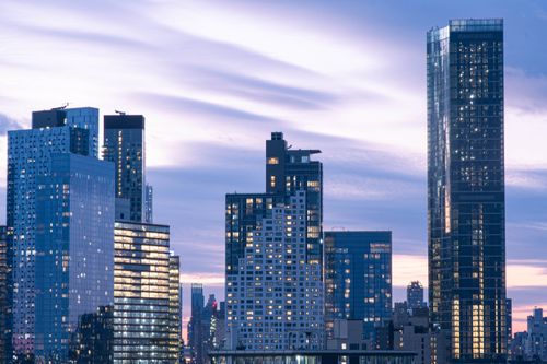 Free Stunning cityscape with illuminated skyline and vibrant twilight sky. Stock Photo