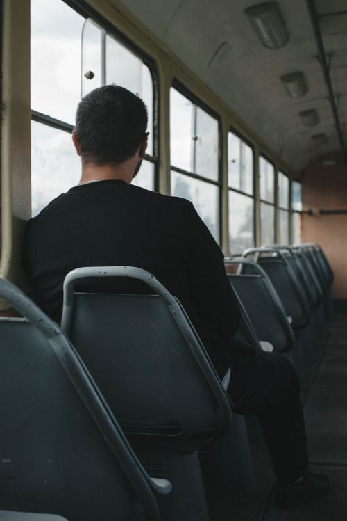 Free A solitary man sits in a quiet tram in Odessa, highlighting urban solitude. Stock Photo