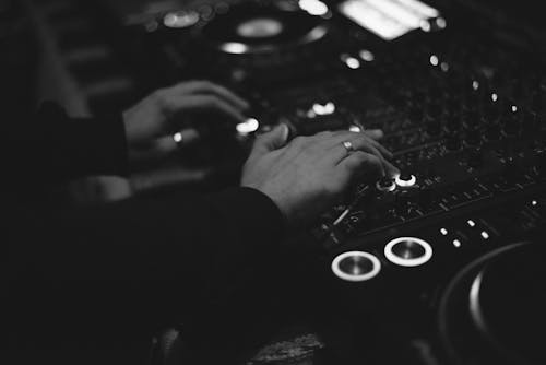 A Person Playing Dj Controller in Grayscale Photography