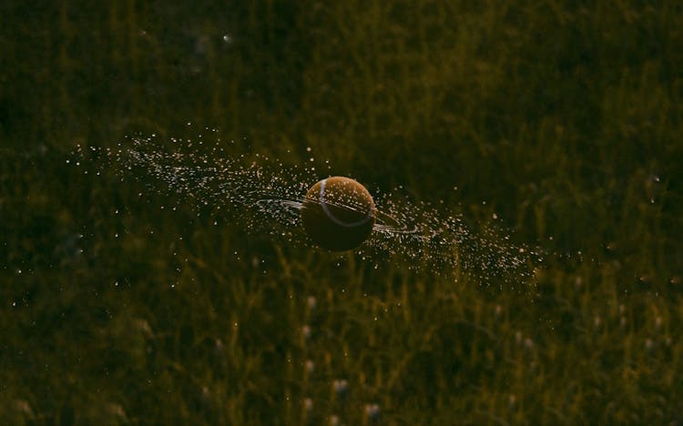 Water Droplets From Spinning Orange Ball