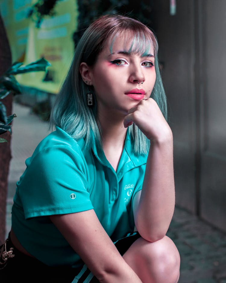 Woman In Blue Polo Shirt With Blue Hair Color 