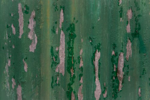 Free Close-up texture of peeling green paint on a concrete wall, perfect for backgrounds or abstract design. Stock Photo