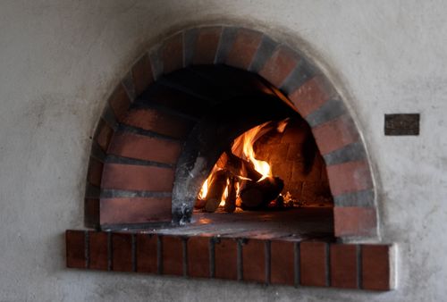 Free Warm and inviting image of a fireplace with burning logs, perfect for cozy indoor settings. Stock Photo