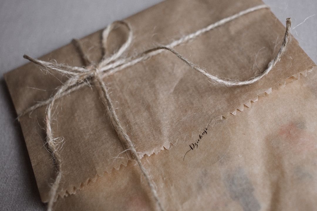 A vintage parcel wrapped in brown kraft paper tied with string, evoking nostalgia.