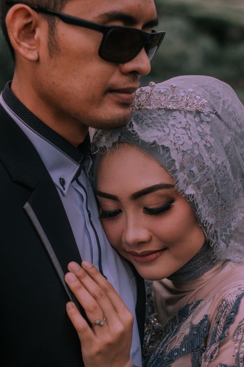 Free Charming prewedding portrait of a stylish couple embracing outdoors, showcasing love and elegance. Stock Photo