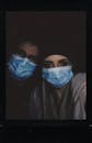 A Couple Wearing Blue Face Mask