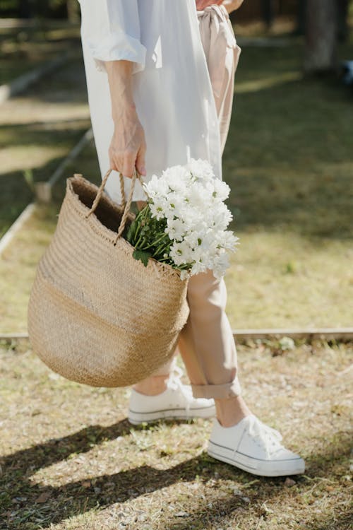 Woman Carrying a Basket of Flowers