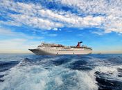 White Cruise Ship on Sea Under Blue Sky and White Clouds