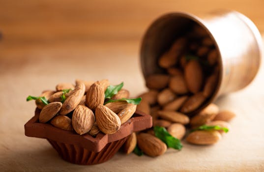 A close-up of almonds in a terracotta bowl with scattered nuts in soft focus, ideal for food photography.