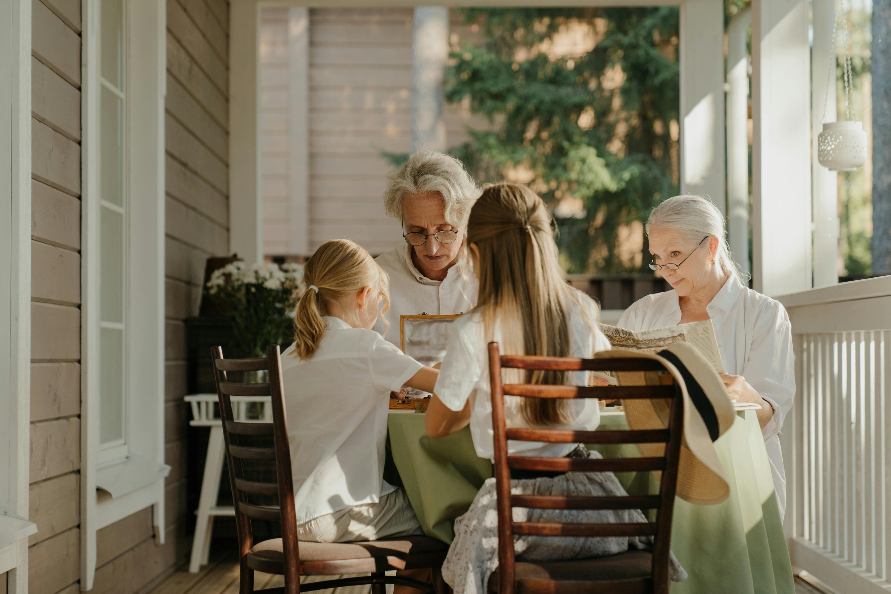 Children Sitting with Grandparents at Table