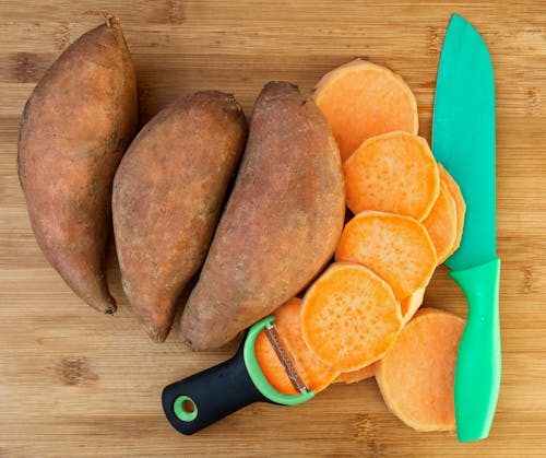 Sweet Potatoes Beside a Knife