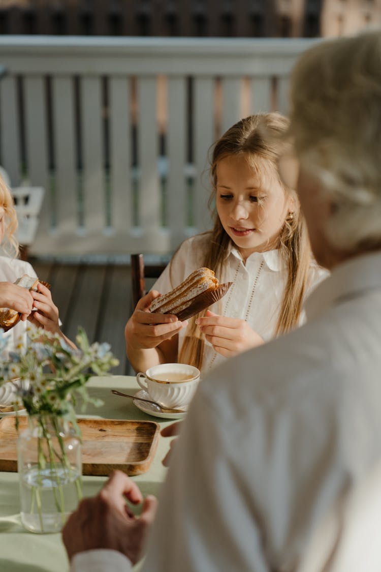 Young Girl Eating A Bread