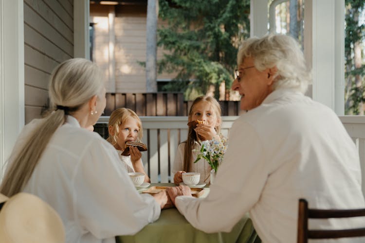 Grandparents And Kids Sitting Together