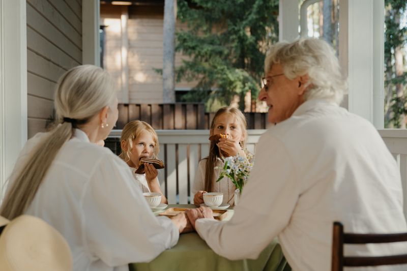 Grandparents sitting together with grandchildren sharing a meal