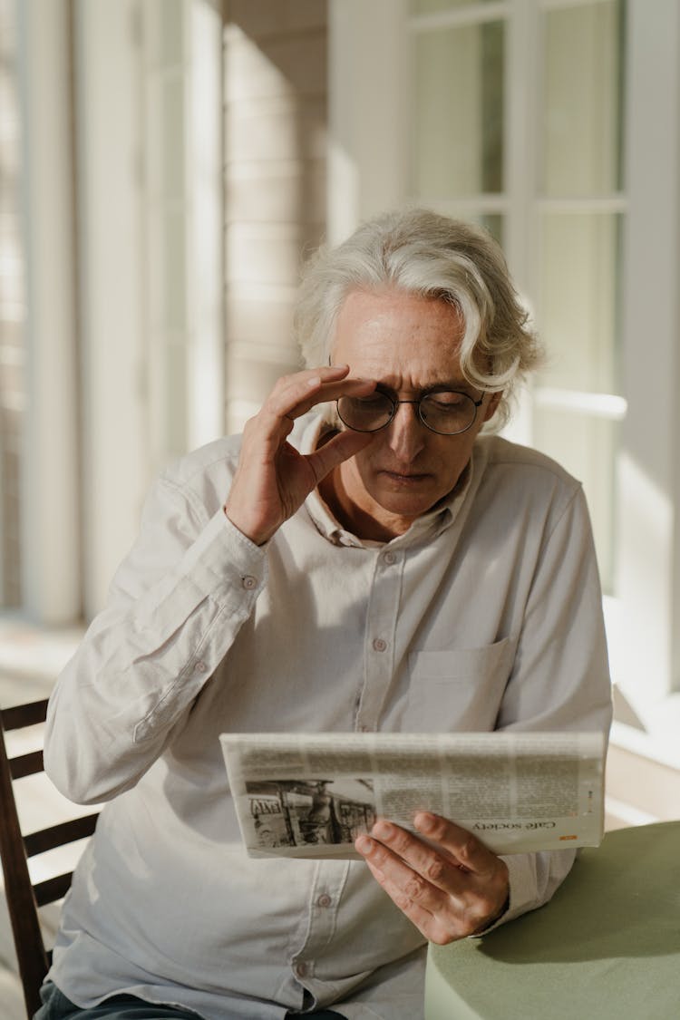 Elderly Man Reading A Newspaper