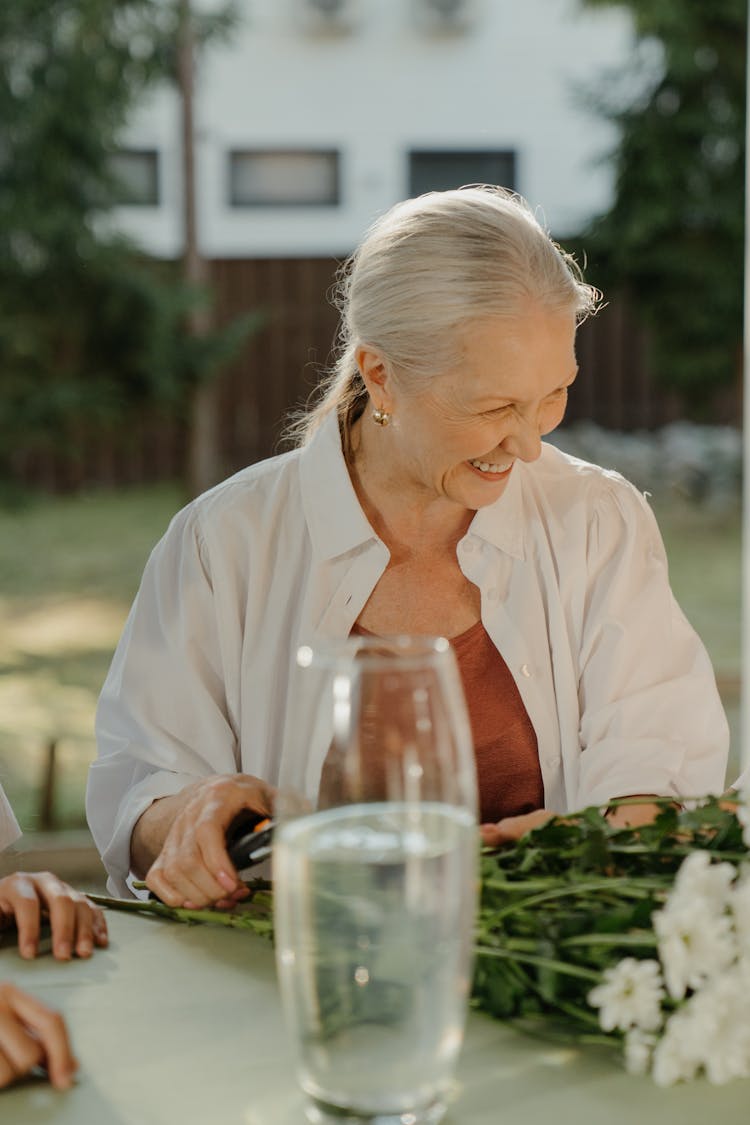 Elderly Woman Smiling While Sitting 