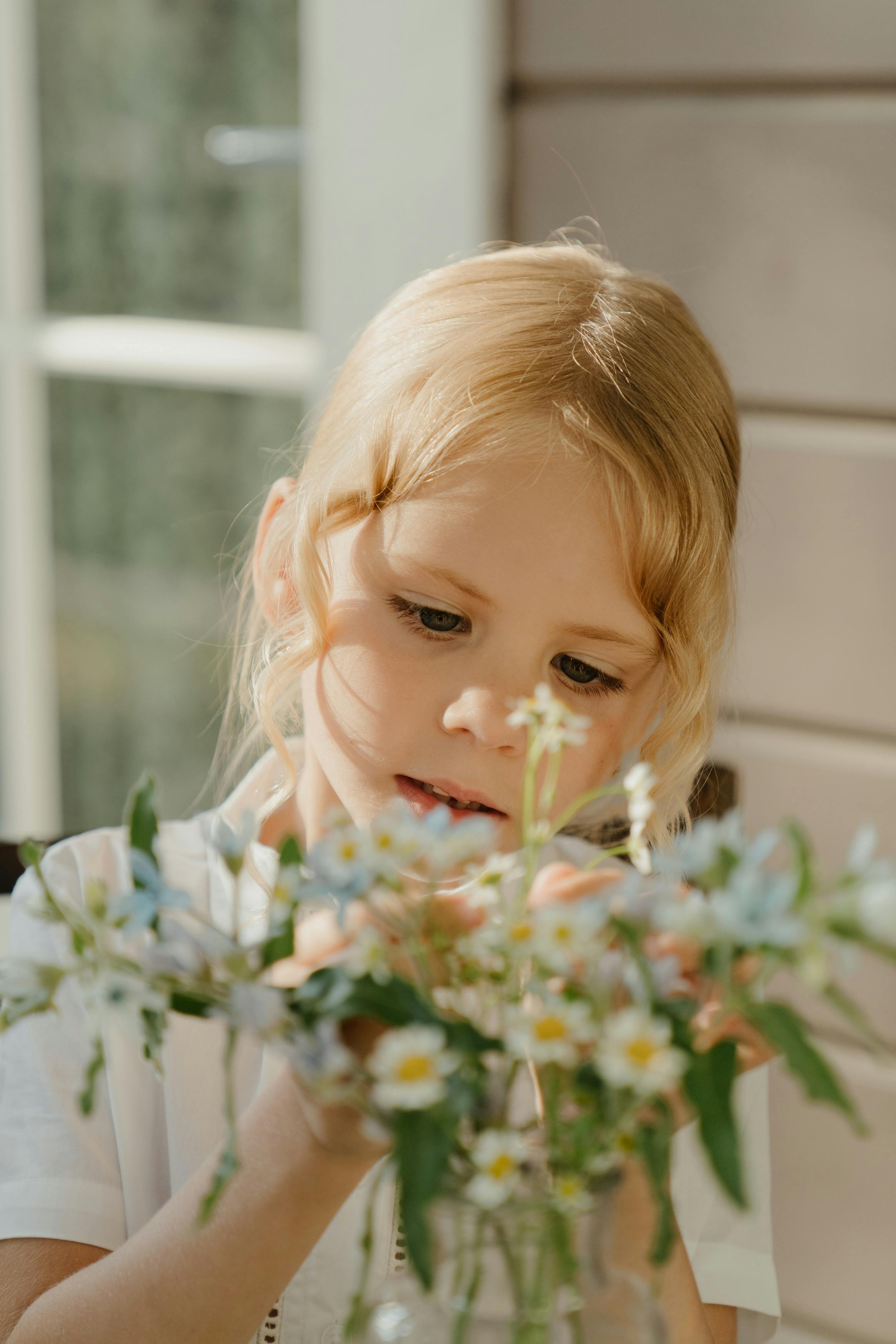 girl in white blouse holding white flowers