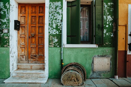 Green Building with Brown Wooden Door 