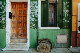 Green Building with Brown Wooden Door 
