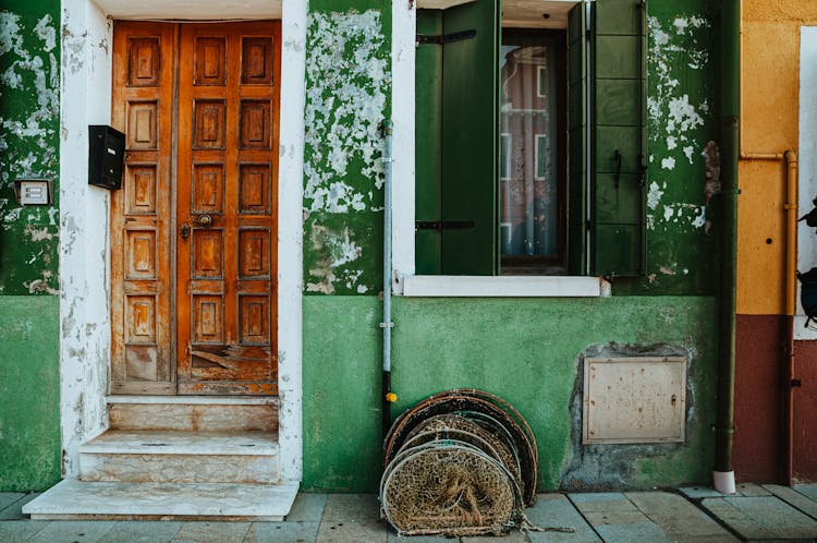 Green Building With Brown Wooden Door 