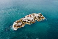 Brown Rock Formation on Body of Water