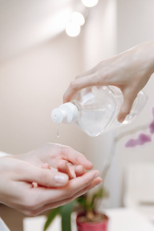 A Person Pouring Hand Sanitizer