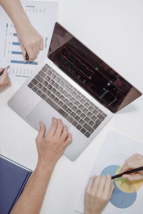 Free Person Using Macbook Pro on White Table Stock Photo