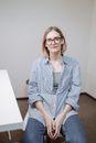 Woman in Blue and White Pinstripe Dress Shirt Wearing Eyeglasses
