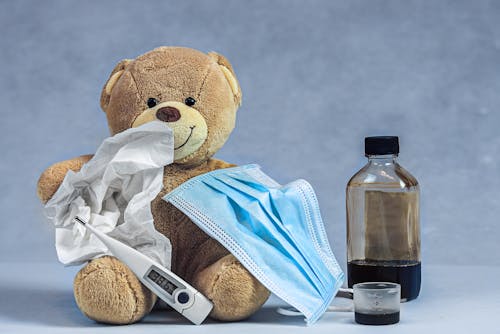 Free Close-Up Shot of a Teddy Bear beside a Thermometer Stock Photo