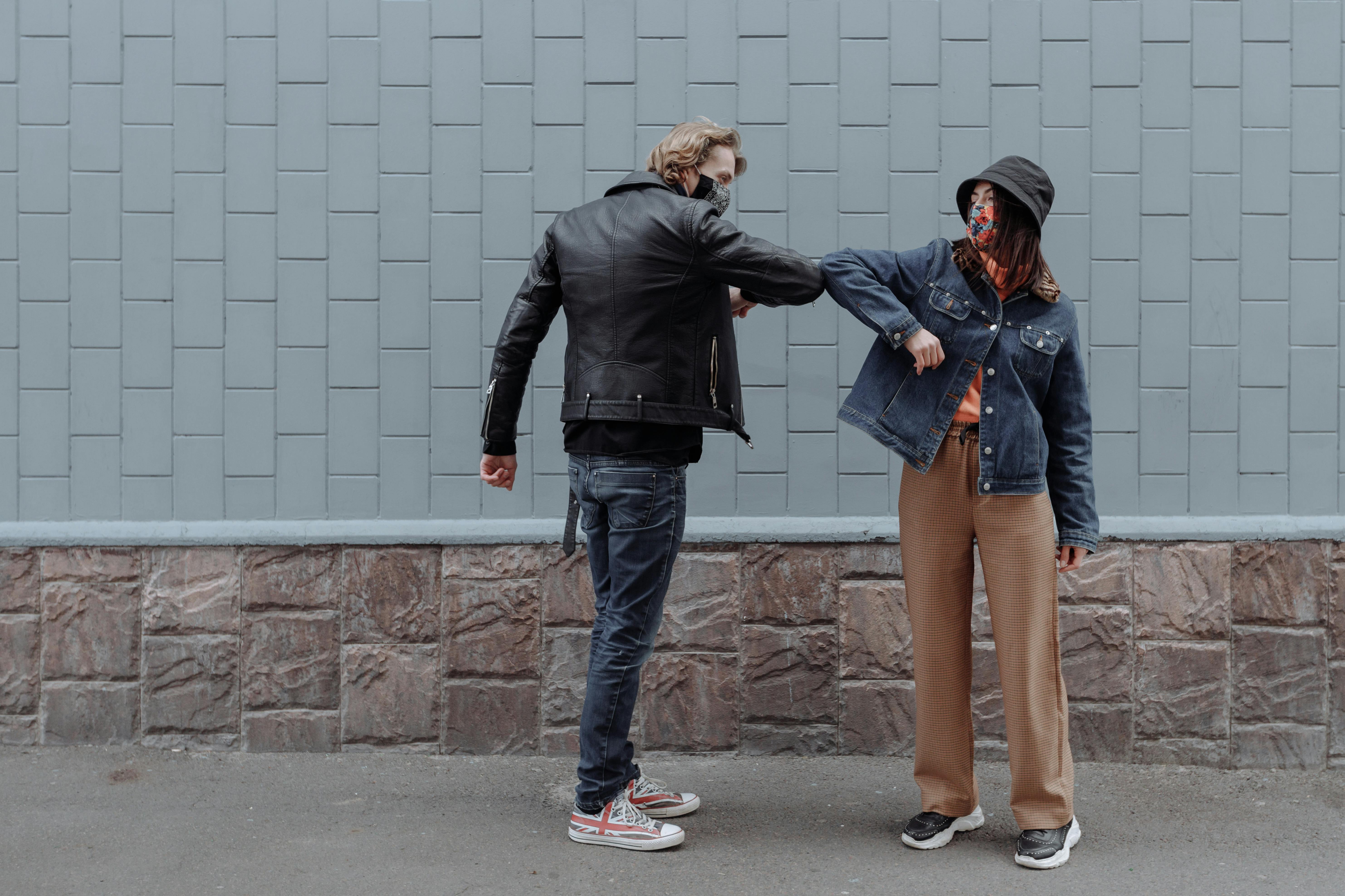 Man in Black Leather Jacket Hugging Woman in Blue Denim Jacket · Free