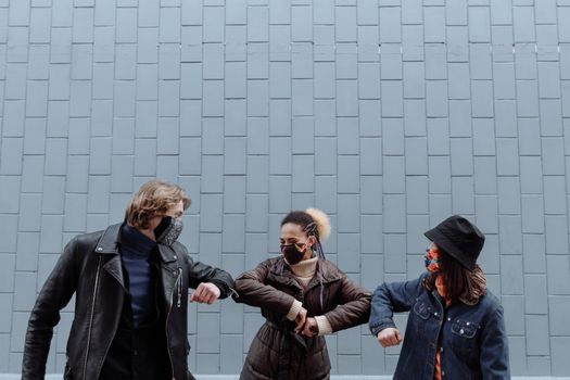 3 Women in Black Jacket Standing Near White Wall