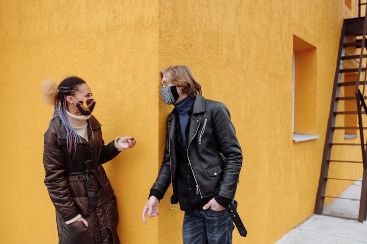 Man And Woman Standing A Building Corner