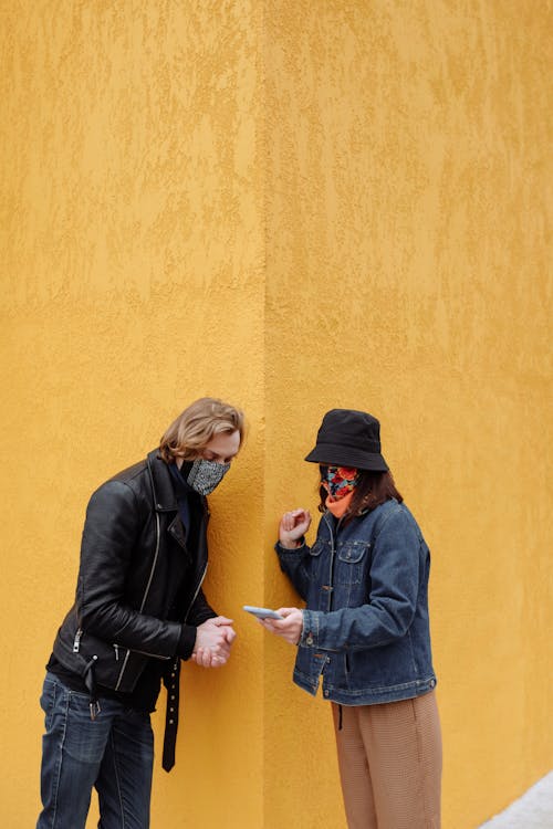 A Woman Showing Her Smartphone to a Man