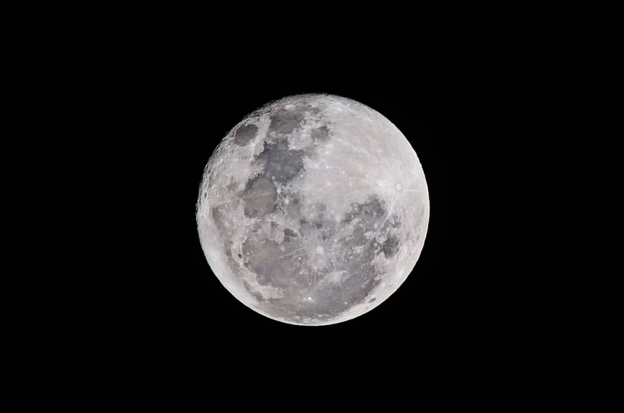detailed full moon captured against a black sky showcasing lunar textu