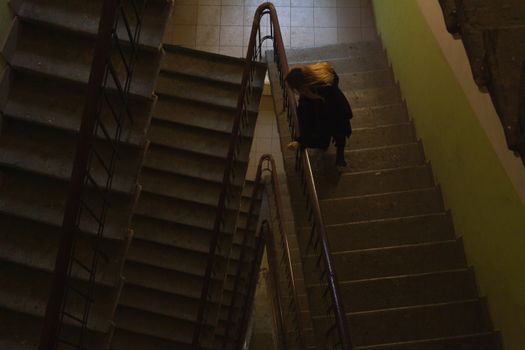 Woman Walking Stairs in Building