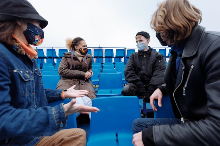 People Wearing Facemasks While Talking Together