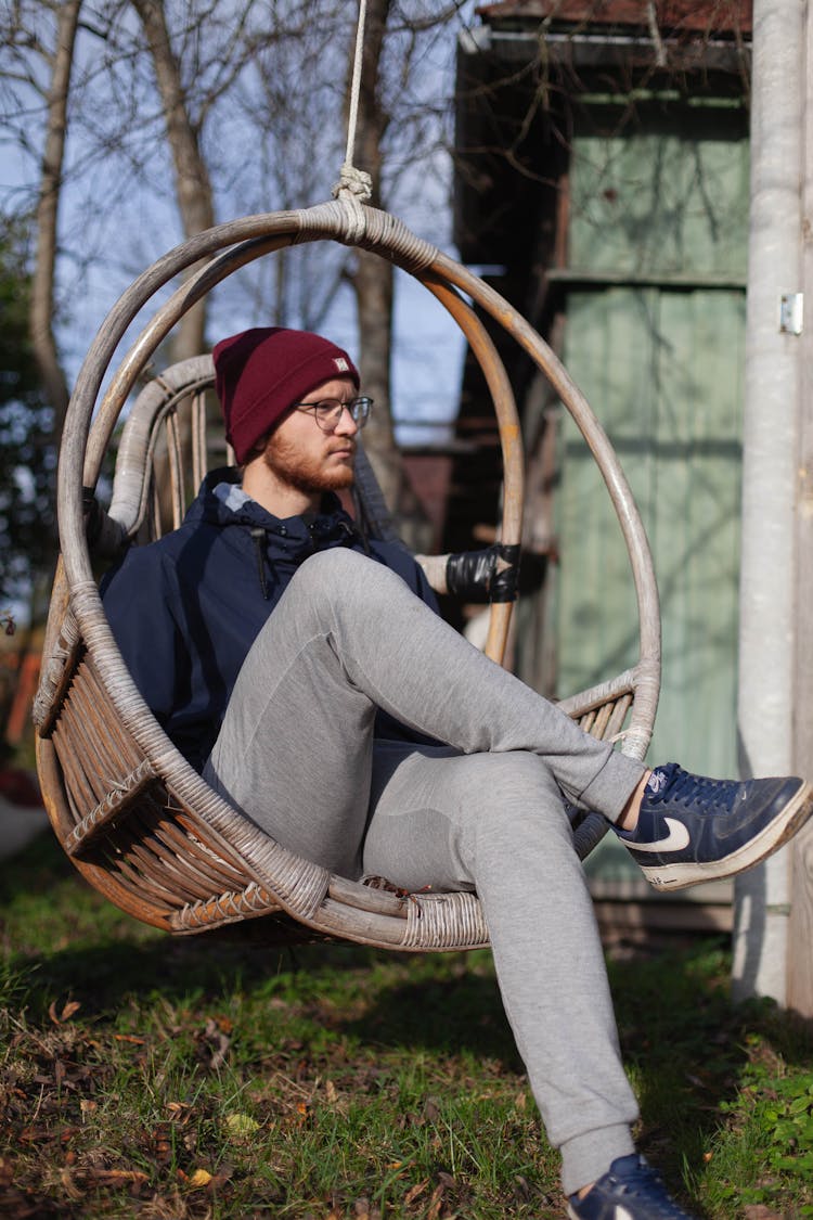 Portrait Of A Man Sitting In A Yard