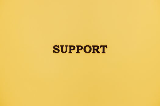 Minimalist image with 'Support' text on a yellow background for conceptual themes.