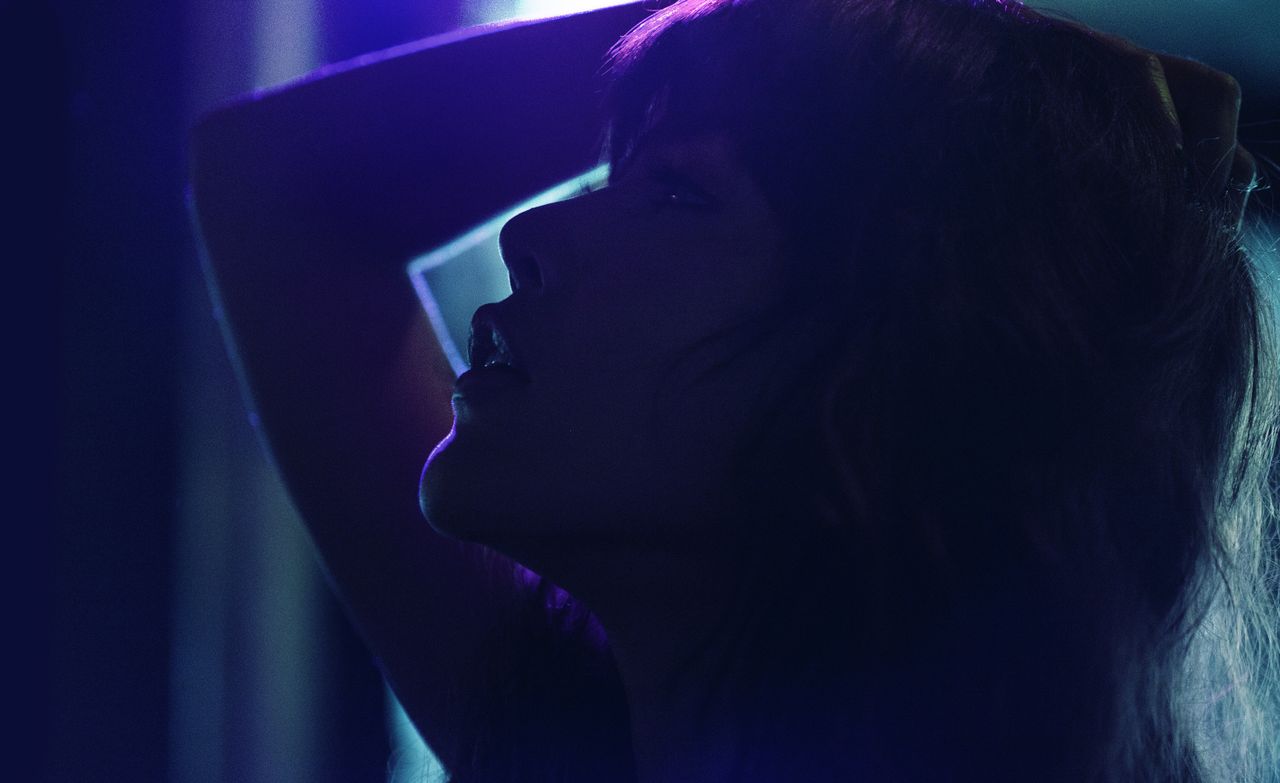 silhouetted woman with dramatic lighting creates a moody nighttime por