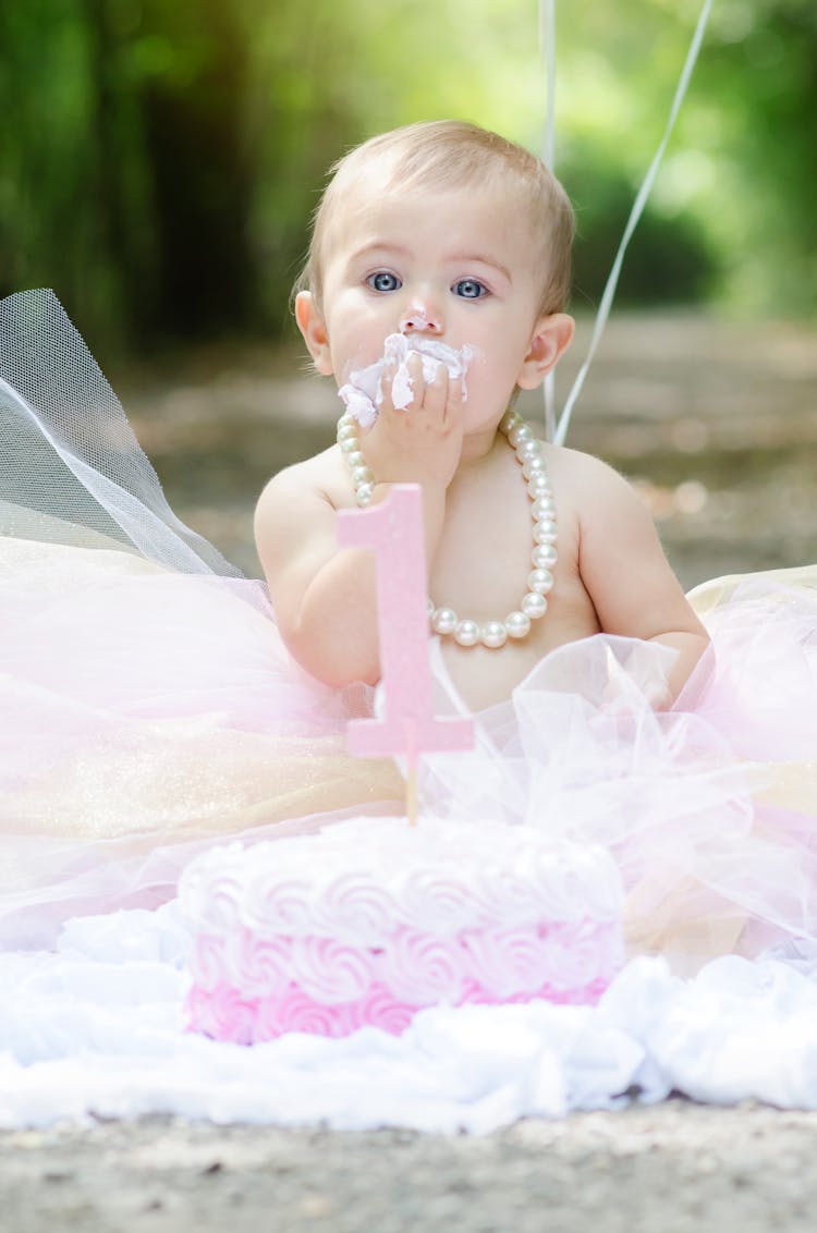 A Baby Eating A Cake