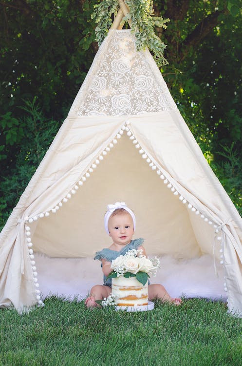 A Girl Sitting inside a Tent 