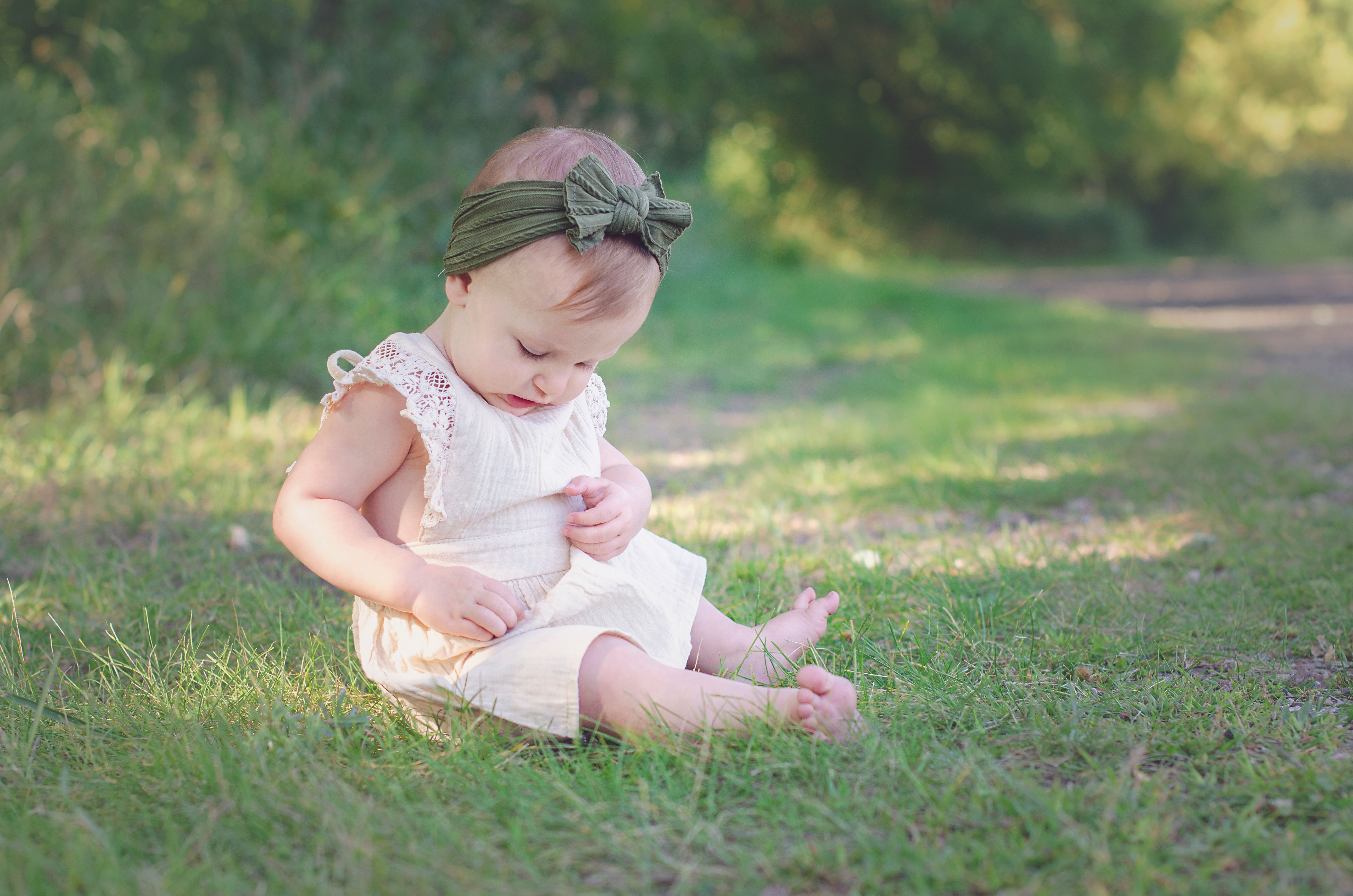 Baby Girl in Pink Dress Sitting on Green Grass · Free Stock Photo