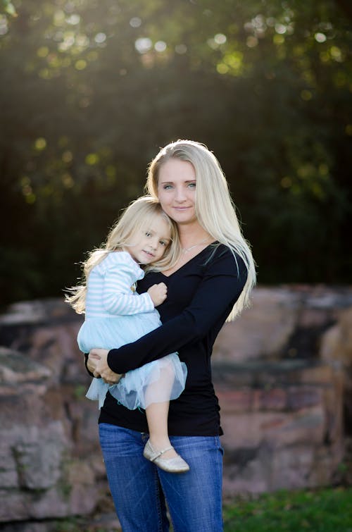 A Woman Carrying Her Daughter