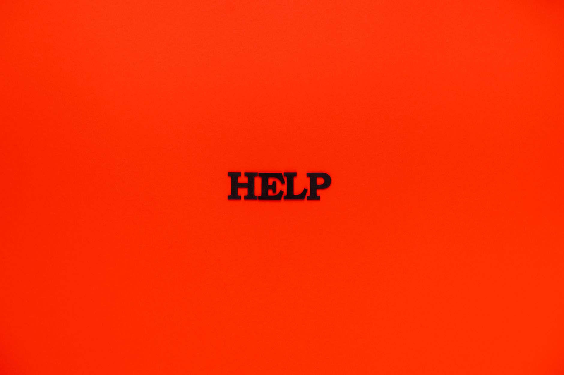 Minimalist red background featuring the word 'HELP' in bold text.