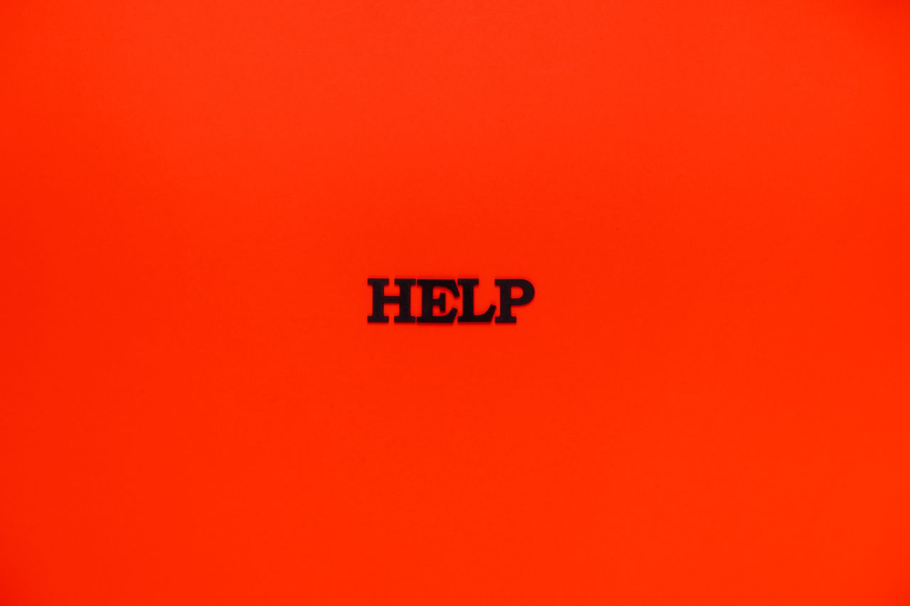 minimalist red background featuring the word help in bold text